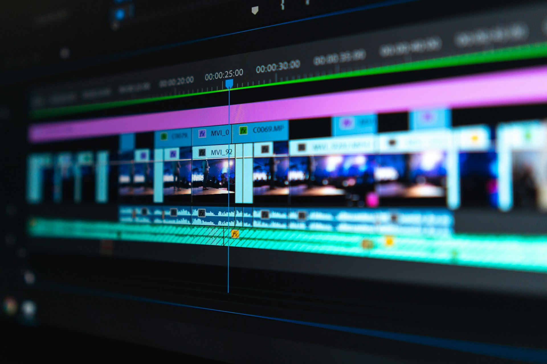 An editing timeline on a monitor in a dark room